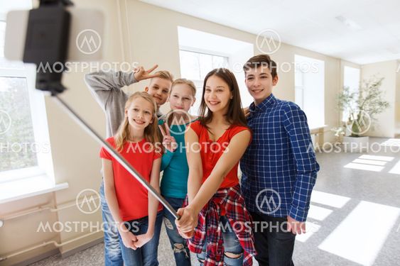 group of students taking selfie with smartphone