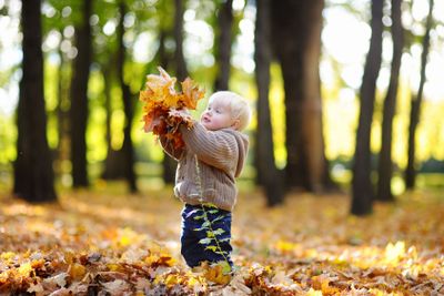 Toddler having fun in autumn 