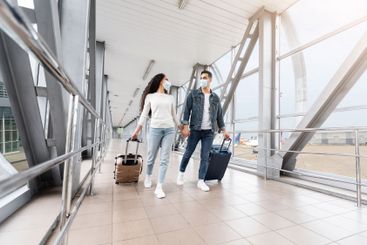 Pandemic Journeys. Young Couple Wearing Medical Face...