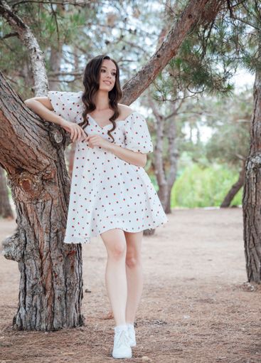 Beautiful slim brunette woman in summer white dress...