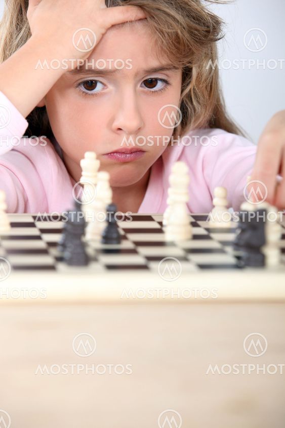 little girl playing chess