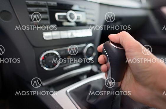 Driver shifting the gear stick