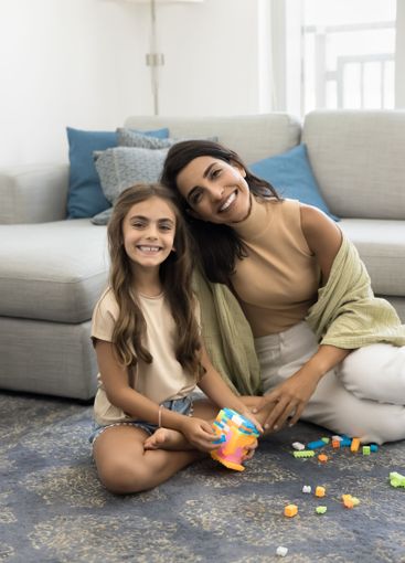 Young mother posing for photo with little daughter