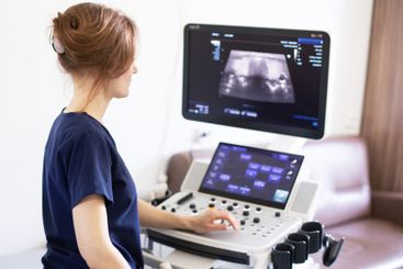 Doctor doing ultrasound scanning diagnostic of thyroid...