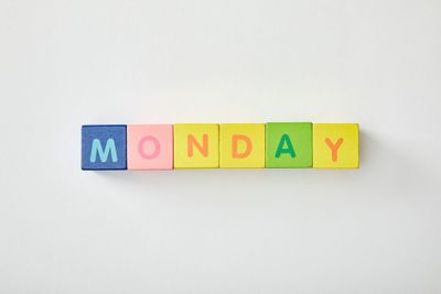 top view of monday lettering made of multicolored cubes...