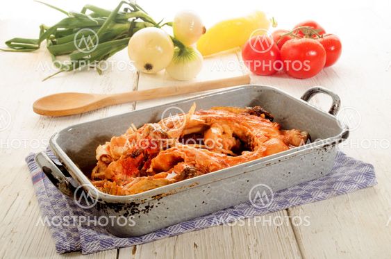 boiled carp in a gray metal cooking tin