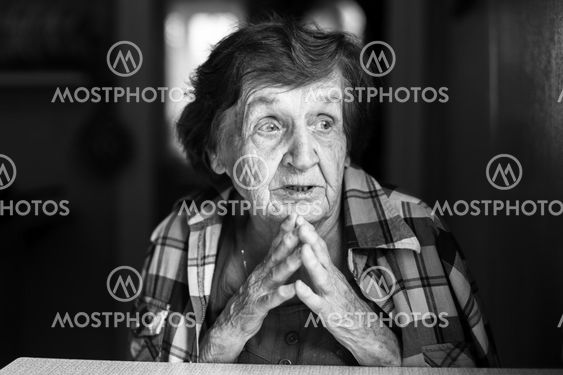 Emotional elderly woman black and white portrait.