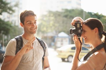Couple, tourism and photographer in street for travel,...