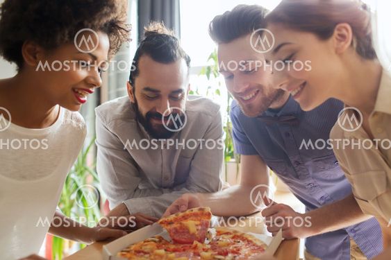 happy business team eating pizza in office