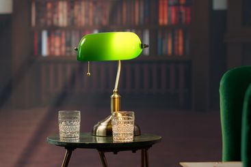 Elegant vintage library with green armchairs and classic...