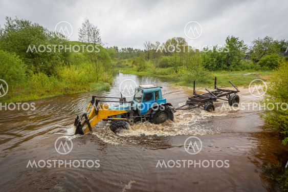 tractor crosses the river