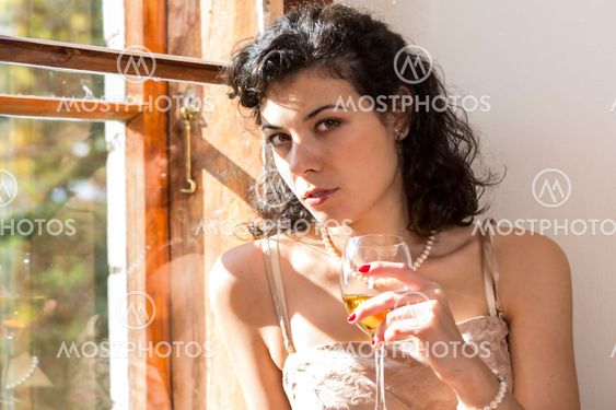 Woman with glass of wine at hand