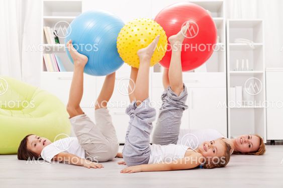 Healthy family exercising at home