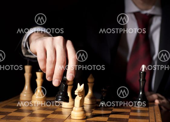 businessman plays chess