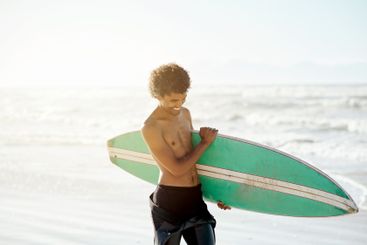 Surfing, man and happy at beach, sea and ocean for...