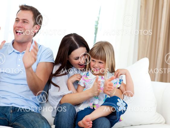 Happy family clapping a goal