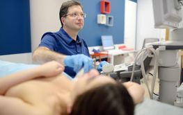 Mammologist doctor examines a woman breasts and lymph...