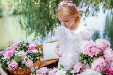 Portrait of a cute little girl in an elegant dress on a...