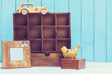Cozy pastel wooden home decor objects on blue background