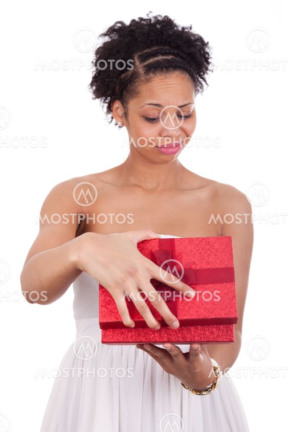 Disappointed young African American woman opening a gift box