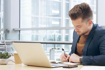 Writing, notebook and laptop with business man in office...