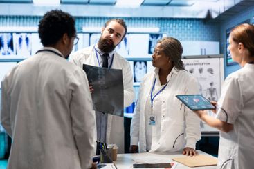 Doctors and nurses analyze human anatomy scans results...