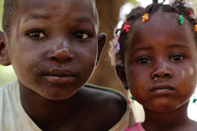 Two Young African Children stare on