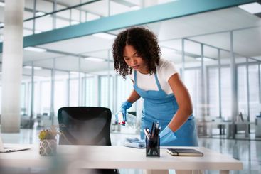 Janitor Cleaning Office Desk
