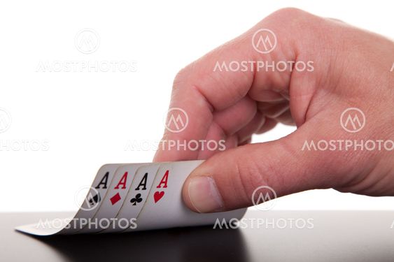 man's hand revealing four aces, isolated on white background, studio shot