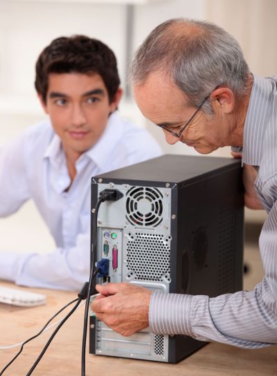 senior technician repairing computer