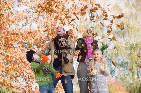 Family throwing leaves in the air