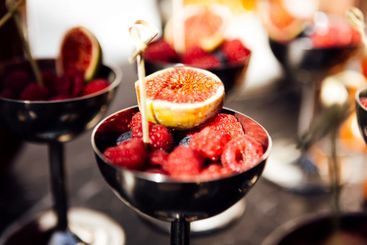 A polished silver bowl is filled with a variety of fresh...