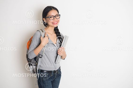 asian female college student with books and laptop