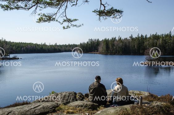 Senior couple resting at lake side