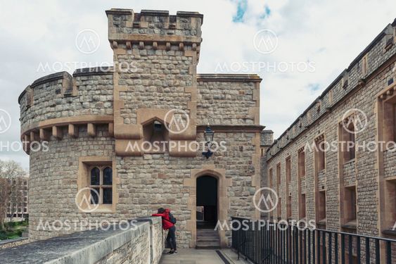 London, UK - April 2018: Old buildings and towers in the inner ward area of Royal Palace and Fortress of the Tower of London, a historic castle and popular tourist attraction located on the north bank of the River Thames in central London, England