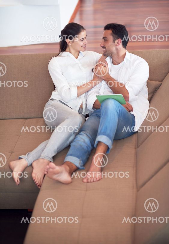 couple at modern home using tablet computer