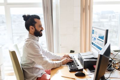 happy creative male office worker with computer