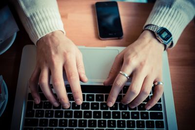 close up hands multitasking man using tablet, laptop and...