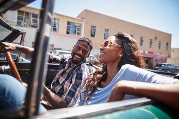 Black couple, convertible and road trip in city, love...
