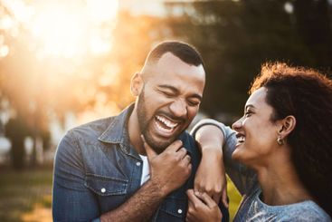 Happy, morning and couple in park laughing together for...