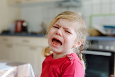Cute upset unhappy toddler girl crying. Angry emotional...