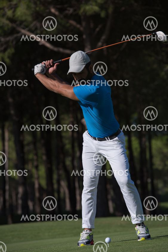 golf player hitting shot