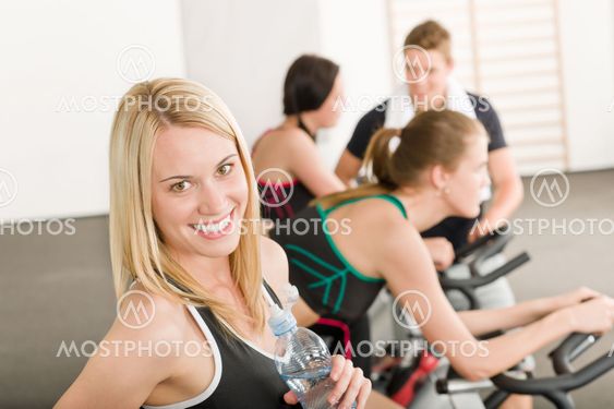Fitness group of people on gym bike
