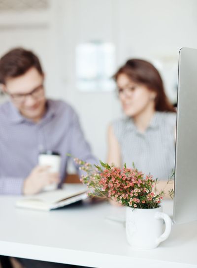 Two creative designers working at white office.