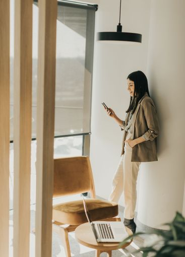 Professional woman engaged in mobile work at a modern...