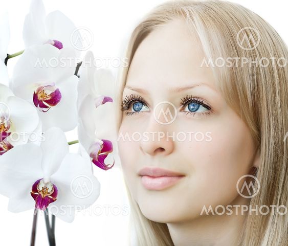 Closeup woman face with white orchid