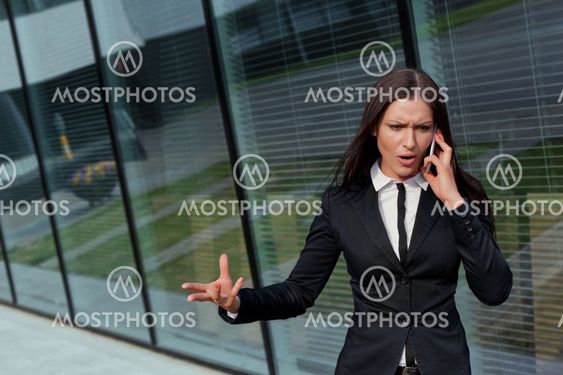 Beautiful business woman bossy on the phone