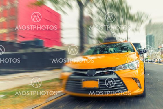 Yellow cab speeding up in New York street
