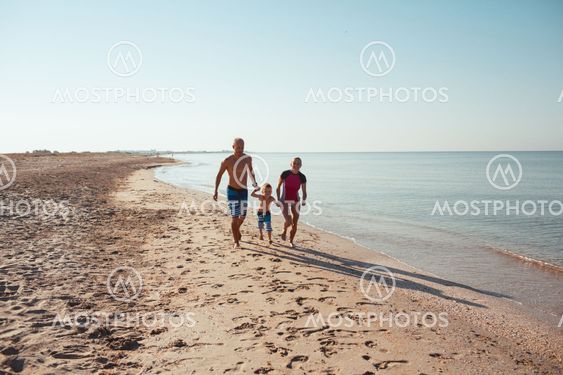 Family on the beach at sunset