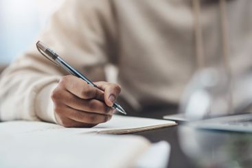 Remote work from home, hands and writing with man,...